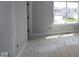 Bright bedroom features a large window letting in natural light and bare floors awaiting your personal touch at 9520 Bauhaus Way, Indianapolis, IN 46240