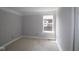 Bedroom with neutral walls, white trim, and a bright window offers a peaceful atmosphere at 9520 Bauhaus Way, Indianapolis, IN 46240
