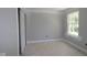 Bedroom with neutral walls, white trim, a closet, and a bright window at 9520 Bauhaus Way, Indianapolis, IN 46240