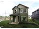 Beautiful exterior of a two-story home featuring green siding and a well-maintained lawn at 9520 Bauhaus Way, Indianapolis, IN 46240