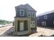 Two-story home featuring a covered porch, double-hung windows, and stylish green siding at 9520 Bauhaus Way, Indianapolis, IN 46240