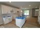 A modern kitchen featuring white cabinets, an island with a sink, and natural lighting at 9520 Bauhaus Way, Indianapolis, IN 46240