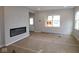 Bright living room featuring an electric fireplace, neutral walls, and large windows at 9520 Bauhaus Way, Indianapolis, IN 46240