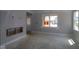 Bright, unfinished living room features large windows and an opening for a fireplace at 9520 Bauhaus Way, Indianapolis, IN 46240