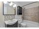 Tiled bathroom featuring vanity with sink and tub shower combination at 10016 Penrith Dr, Indianapolis, IN 46229