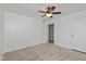 Spacious bedroom featuring carpet, ceiling fan and a closet for storage at 10016 Penrith Dr, Indianapolis, IN 46229