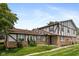 Charming townhome featuring a well-manicured lawn, brick accents, and a welcoming front porch at 10016 Penrith Dr, Indianapolis, IN 46229