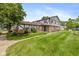 Charming townhome showcasing a well-manicured lawn and Tudor-style accents at 10016 Penrith Dr, Indianapolis, IN 46229