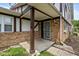 A closer look at the cozy front porch of the home, leading to an ornate, secure front door at 10016 Penrith Dr, Indianapolis, IN 46229