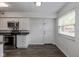 Bright kitchen with stainless steel appliances and hardwood floors, offering room for dining at 10016 Penrith Dr, Indianapolis, IN 46229