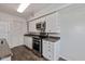 Kitchen with stainless steel appliances, white cabinetry, and hardwood flooring at 10016 Penrith Dr, Indianapolis, IN 46229