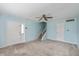 Spacious living room with carpet and a staircase, filled with natural light at 10016 Penrith Dr, Indianapolis, IN 46229