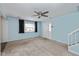Inviting living room with neutral carpeting, blue painted walls, and a ceiling fan at 10016 Penrith Dr, Indianapolis, IN 46229