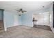 Open living space with carpet and views of the kitchen featuring updated appliances at 10016 Penrith Dr, Indianapolis, IN 46229