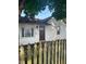 Charming home with a tidy lawn, a rustic fence and a freshly painted front door at 1006 Hurricane St, Franklin, IN 46131