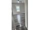 Hallway featuring new vinyl flooring, neutral paint, and a window at the end of the hall at 1006 Hurricane St, Franklin, IN 46131