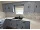 Close up of gray cabinets, white countertops, and subway tile backsplash at 1006 Hurricane St, Franklin, IN 46131