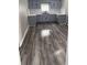 A kitchen featuring light gray cabinets, white backsplash, and gray hardwood floors at 1006 Hurricane St, Franklin, IN 46131