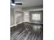 The inviting living room offers new flooring, neutral gray walls, and lots of natural light from updated windows at 1006 Hurricane St, Franklin, IN 46131