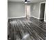 Open-concept living room featuring new vinyl flooring, neutral paint, and a ceiling fan at 1006 Hurricane St, Franklin, IN 46131