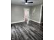 Living room features new wood flooring, modern ceiling fan, and neutral gray walls, perfect for relaxation at 1006 Hurricane St, Franklin, IN 46131