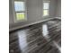 Spacious living room featuring new vinyl flooring, neutral paint, and natural light from bright windows at 1006 Hurricane St, Franklin, IN 46131