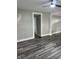 Bright living room featuring gray wood flooring, freshly painted walls, and modern lighting fixtures at 1006 Hurricane St, Franklin, IN 46131
