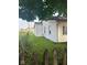 Grassy side yard showing home's exterior and fencing at 1006 Hurricane St, Franklin, IN 46131