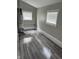 Utility room features modern gray flooring, neutral walls, and two bright windows at 1006 Hurricane St, Franklin, IN 46131