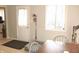 View of the dining area showcasing the door, window, and a table with gray chairs at 103 Bentwood Dr, Greenwood, IN 46143