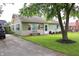 Charming single-story home with green siding, manicured lawn, and an asphalt driveway at 103 Bentwood Dr, Greenwood, IN 46143