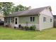Single-story home showcasing green siding, an inviting front entrance, and decorative landscaping at 103 Bentwood Dr, Greenwood, IN 46143