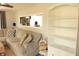 Bright living room featuring a sectional sofa, a built-in bookshelf, and a view into the kitchen at 103 Bentwood Dr, Greenwood, IN 46143