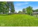Lush backyard with mature trees providing ample shade and privacy, ideal for outdoor entertaining at 108 Bennett Rd, Carmel, IN 46032