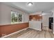 Inviting dining area with wood-look flooring, bright windows, and modern lighting at 108 Bennett Rd, Carmel, IN 46032