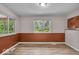 Bright dining area with laminate flooring, large windows and paneled lower walls at 108 Bennett Rd, Carmel, IN 46032