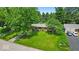 A house surrounded by trees and lush green grass offers an inviting curb appeal at 108 Bennett Rd, Carmel, IN 46032