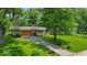 A well-kept lawn compliments the house's exterior, complete with a two-car garage and mature trees at 108 Bennett Rd, Carmel, IN 46032