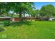 Well-kept single-story home featuring a lush green lawn and mature shade trees at 108 Bennett Rd, Carmel, IN 46032
