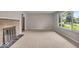 Bright living room with a fireplace, large window and neutral carpet at 108 Bennett Rd, Carmel, IN 46032