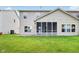 Back exterior view of a home with a well-manicured lawn and a screened-in patio at 1138 Topp Creek Dr, Indianapolis, IN 46214