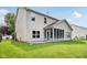 Back exterior view of a home with a well-manicured lawn and a screened-in patio at 1138 Topp Creek Dr, Indianapolis, IN 46214
