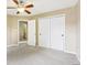 Neutral bedroom featuring ceiling fan and closet with a view to the bathroom at 1138 Topp Creek Dr, Indianapolis, IN 46214