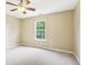 Bright bedroom featuring a window with view of lush greenery and neutral walls at 1138 Topp Creek Dr, Indianapolis, IN 46214