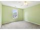 Cozy bedroom with carpet, a ceiling fan, green-painted walls and one window at 1138 Topp Creek Dr, Indianapolis, IN 46214