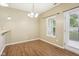 Dining area featuring wood floors and an adjacent door to the backyard at 1138 Topp Creek Dr, Indianapolis, IN 46214