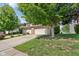 A view of a well-manicured lawn, attached garage, and delightful red roses at 1138 Topp Creek Dr, Indianapolis, IN 46214