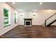 Bright basement with cozy fireplace, staircase, and big windows overlooking the yard at 1210 Churchman Ave, Indianapolis, IN 46203