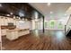 Open basement featuring a kitchen island, appliances, and dark wood floors and staircase at 1210 Churchman Ave, Indianapolis, IN 46203
