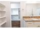 Bathroom featuring a granite vanity and a view into the walk-in closet with custom shelving at 1210 Churchman Ave, Indianapolis, IN 46203